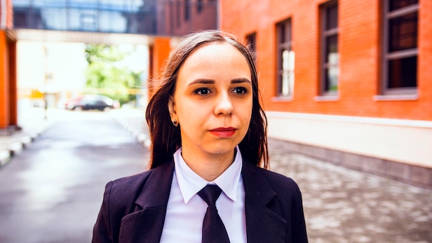 Young woman in business suit on city street Business woman posing