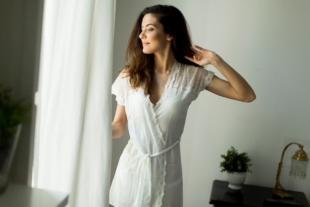 Young woman by the window