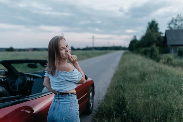 young woman in cabriolet in summer youth and travel concept