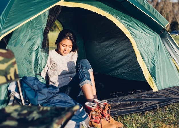 Young Woman camping in forest on summer