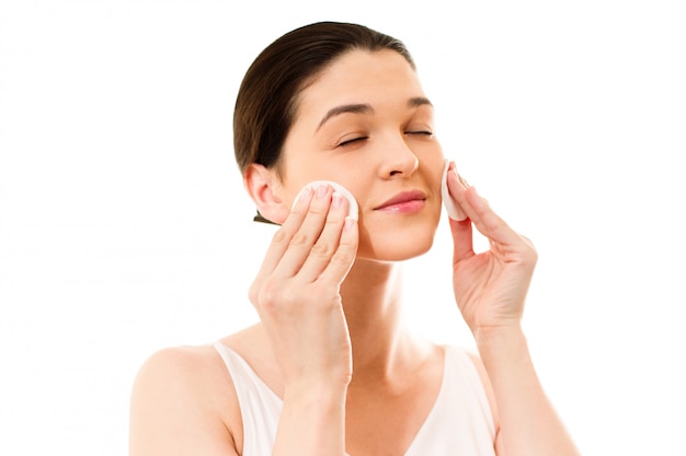 Young woman cares for face skin relaxation, leisure, neck, innocence, bright, serene, sexuality, Woman using cotton pad