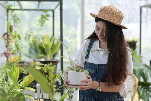 Young woman caring for trees planting and caring equipment plants in greenhouses small businesses