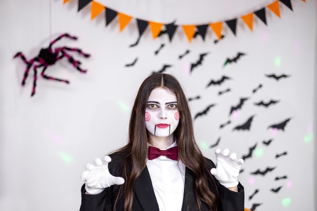 Young woman in carnival costume and face painting at halloween party