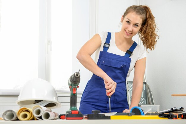 Young woman carpenter working in his studio