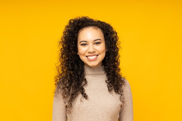 Young woman in casual wearing on yellow background