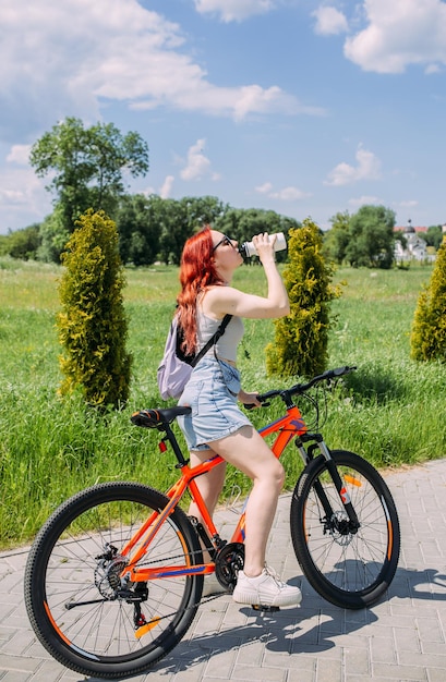 Young woman in the city rides bike and leads an active lifestyle doing sports