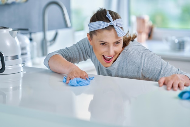 Young woman cleaning dirt in the kitchen