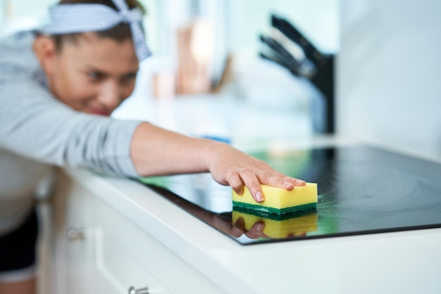 Young woman cleaning dirt in the kitchen