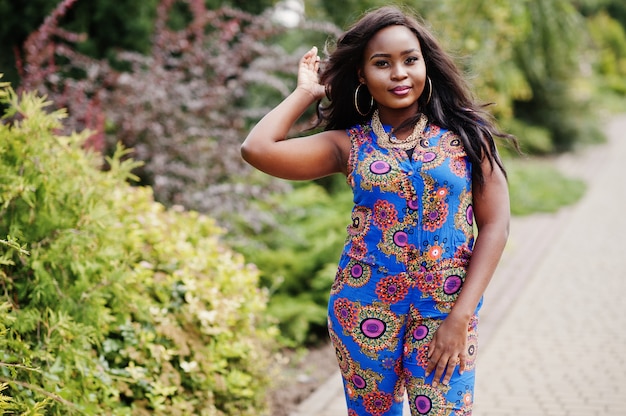 Young woman in coloured clothes posed outdoor