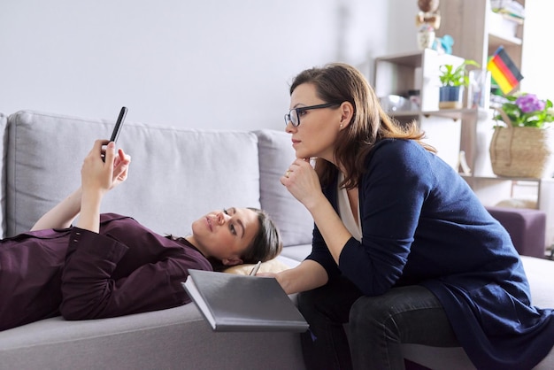 Young woman at consultation with psychologist Female patient lying on couch