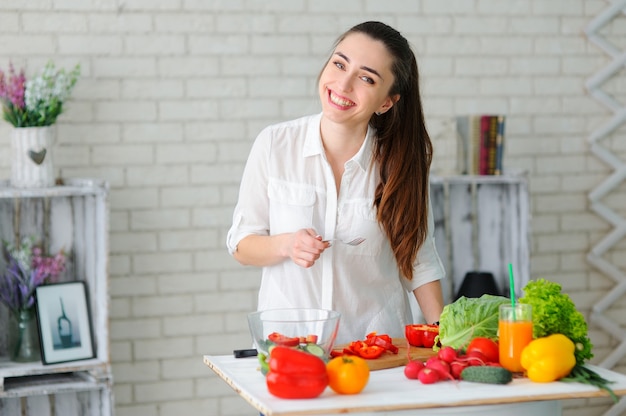 Young Woman Cooking Healthy Vegetable Salad