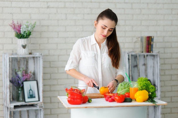 Young Woman Cooking Healthy Vegetable Salad