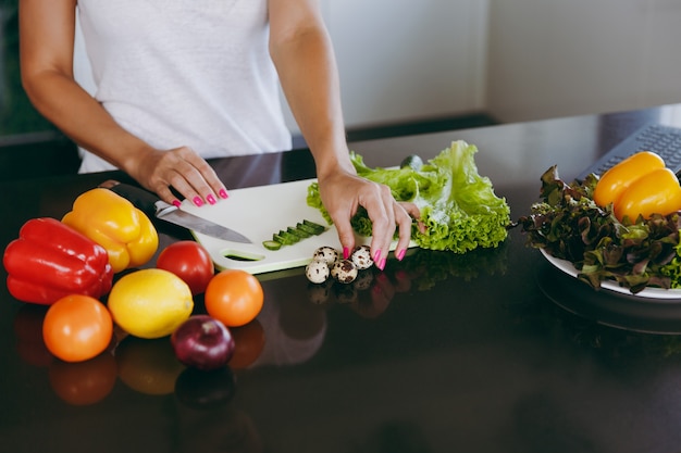 The young woman cooking in the kitchen