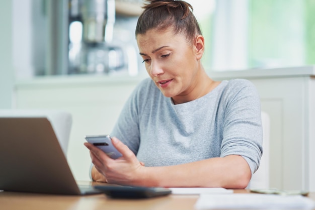 Young woman counting home budget with bills