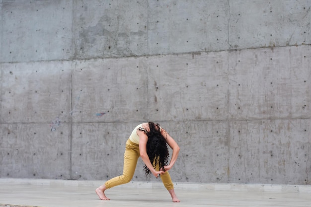 Young woman dancing in an empty stage