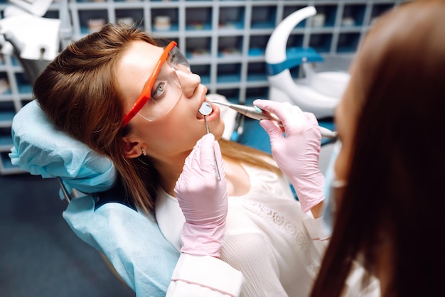 Young woman at the dentist's chair during a dental procedure Overview of dental caries prevention