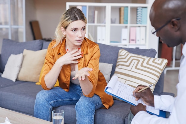 Young woman discussing complexes with therapist