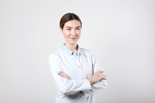 young woman doctor on light background closeup