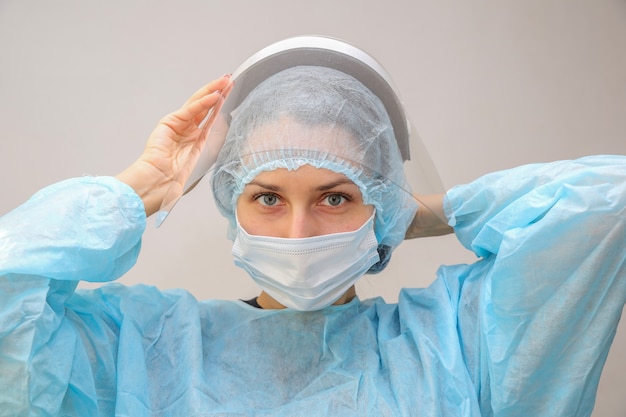 young woman doctor nurse in protective mask