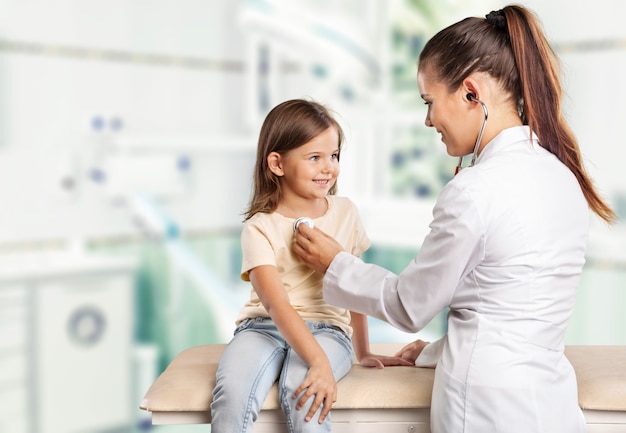 Young woman doctor with little girl  in a hospital