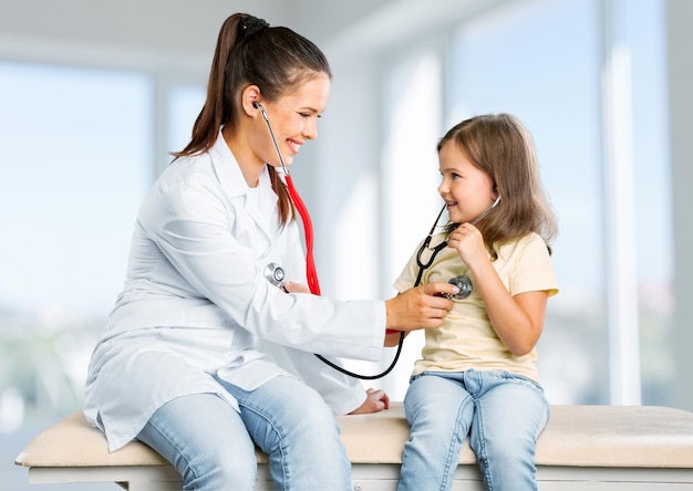 Young woman doctor with little girl