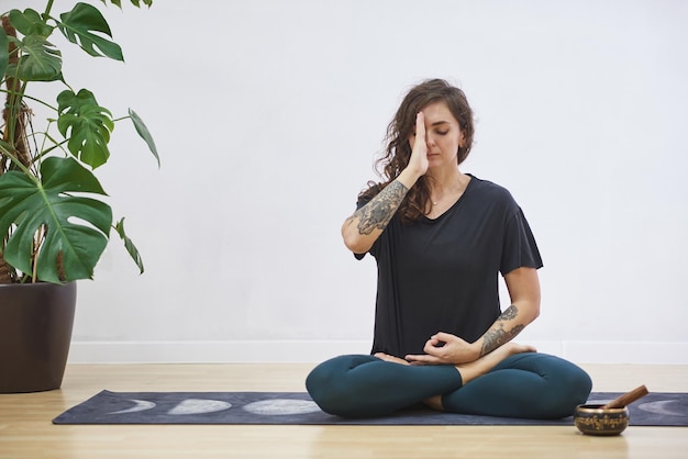 Young woman doing fitness at home The girl goes in for sports on a rug Woman doing yoga