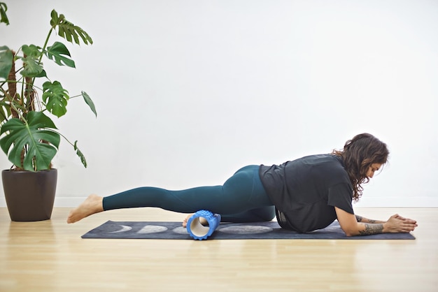 Young woman doing fitness at home The girl goes in for sports on a rug Woman doing yoga