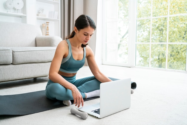 Young woman doing her workout on a fitness mat