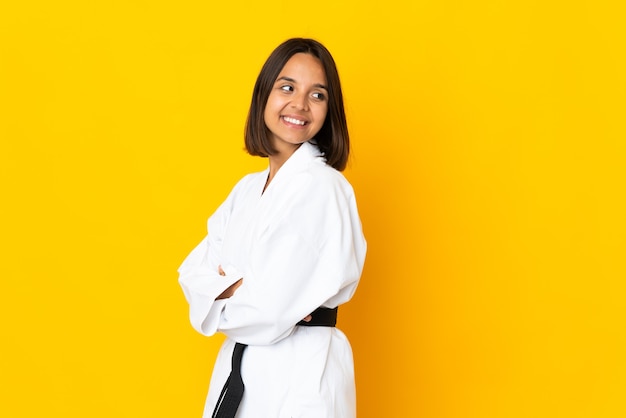 Young woman doing karate isolated