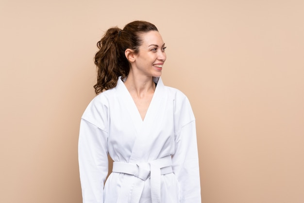 Young woman doing karate looking side