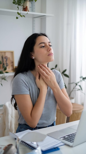 Photo young woman doing thyroid self examination indoors