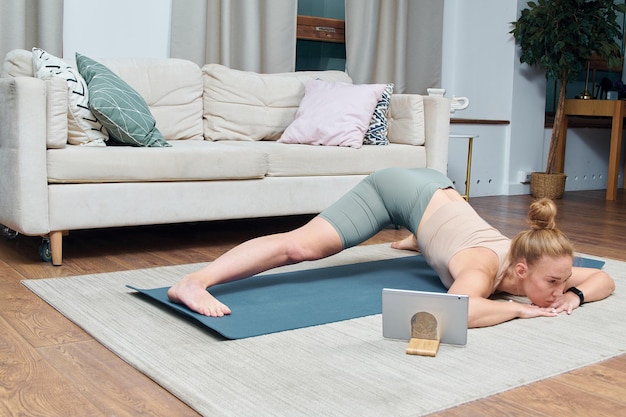 young woman doing yoga excercise in a room at home