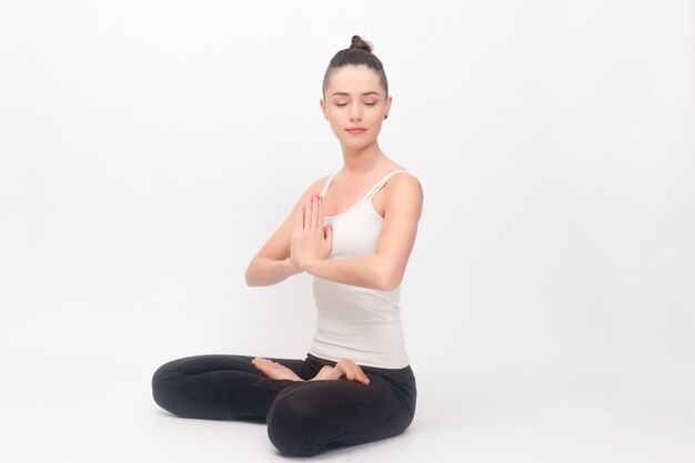 young woman doing yoga exercise portrait of young beautiful girl in white sportswear doing yoga