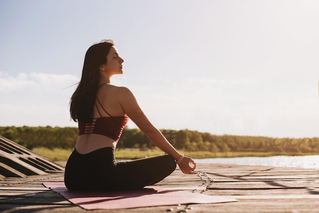 Young woman doing yoga meditation outdoors