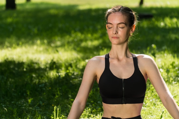 Young woman doing yoga in the park