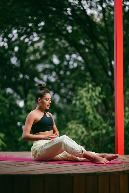 A young woman in doing yoga in the yard