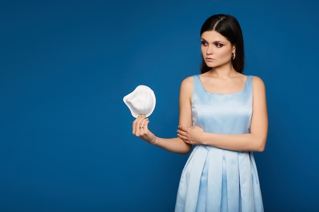 Young woman in dress and medical mask posing