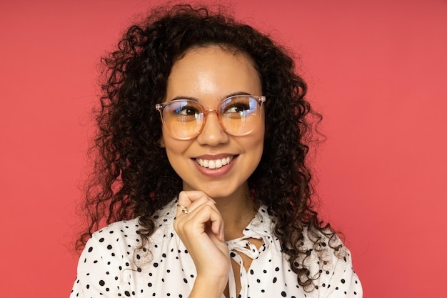 Young woman in dress on pink background