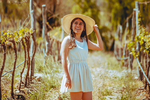 Young woman in dress possing in park