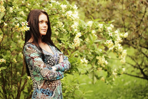 Young woman in dress relaxing in garden