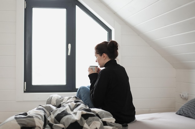 Young woman drink coffee and enjoy a wonderful morning in the light room at home