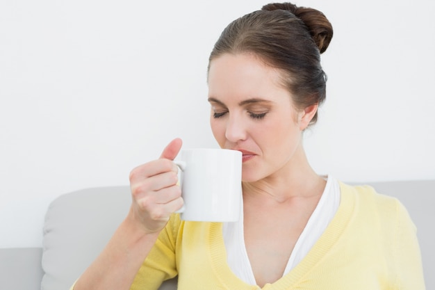 Young woman drinking coffee at home