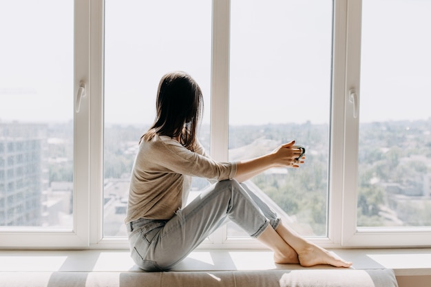 Young woman drinking coffee at home