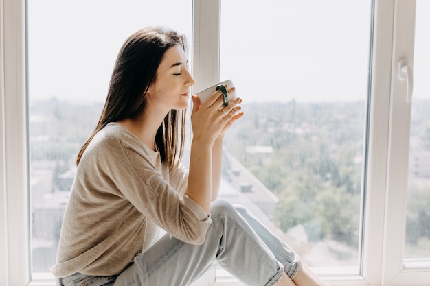 Young woman drinking coffee at home