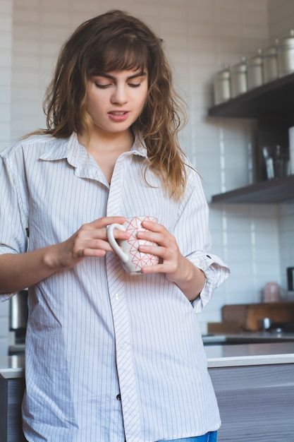 Young woman drinking coffee at home