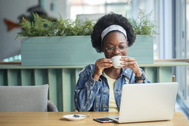 Young woman drinking a cup of coffee