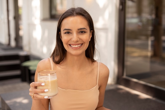 Young woman drinking iced coffee