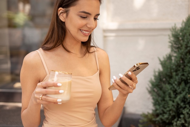 Young woman drinking iced coffee