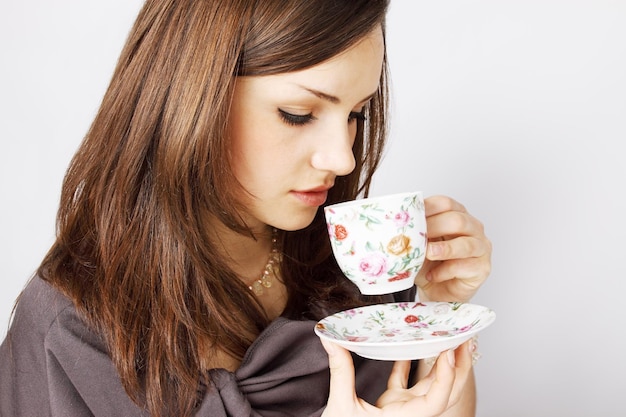 Young woman drinking tea from a cup