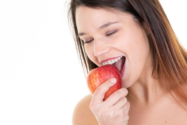 Young woman eating an apple in closeup beauty face girl